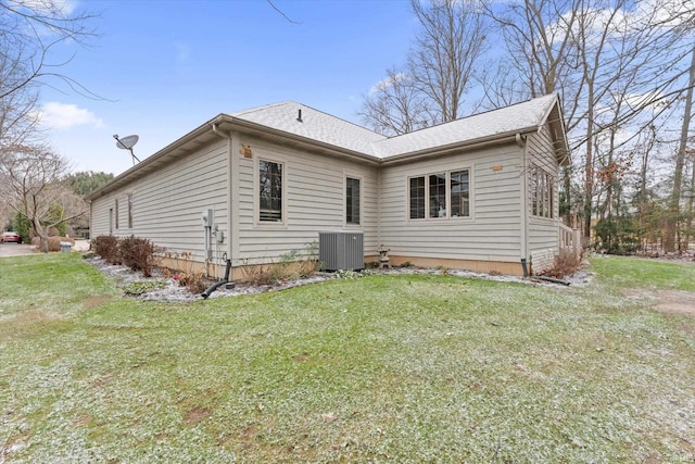 exterior space featuring central AC unit and a yard