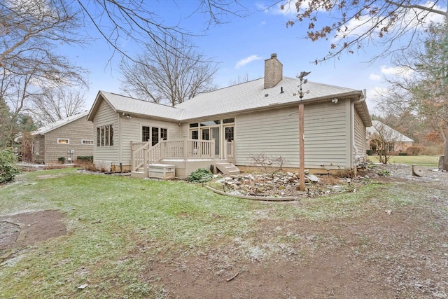 rear view of property featuring a yard and a wooden deck