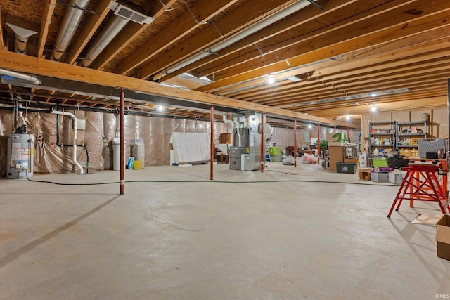 basement featuring gas water heater and heating unit