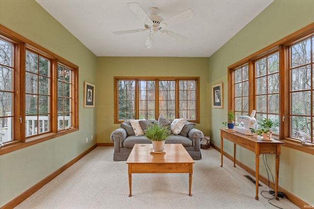 living room featuring light carpet, a wealth of natural light, and ceiling fan