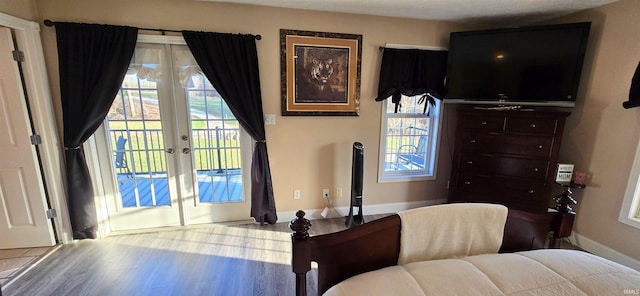 bedroom featuring access to exterior, french doors, and light wood-type flooring