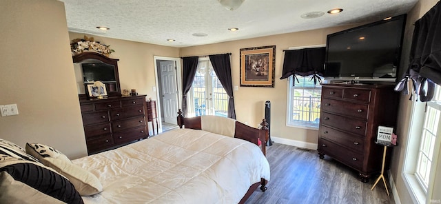 bedroom with hardwood / wood-style floors, a textured ceiling, and french doors