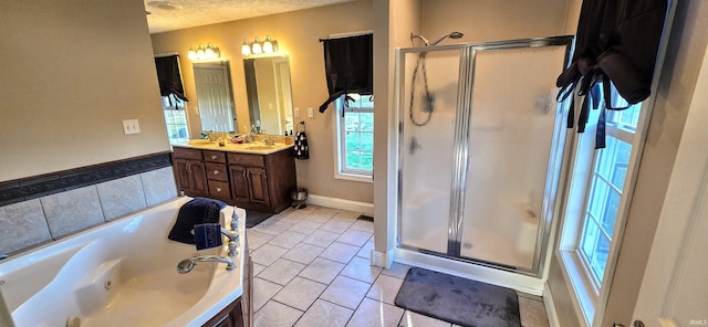 bathroom with tile patterned flooring, vanity, separate shower and tub, and a textured ceiling