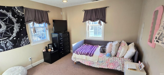 carpeted bedroom featuring multiple windows