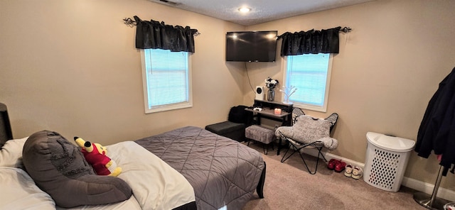 bedroom with carpet floors and multiple windows