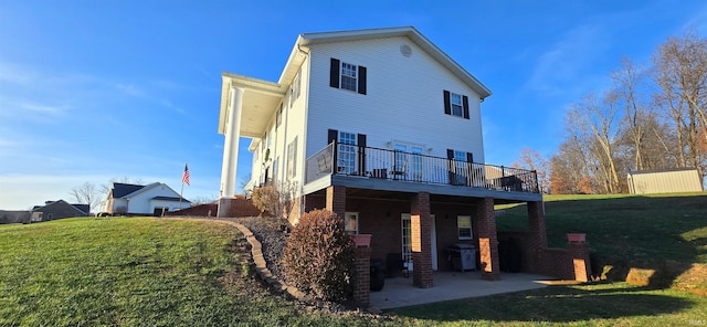 rear view of house with a patio, a deck, and a lawn