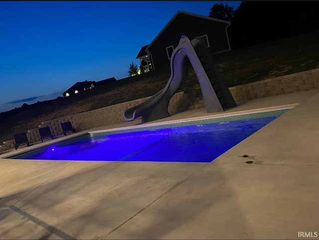 view of swimming pool featuring a patio area and a water slide