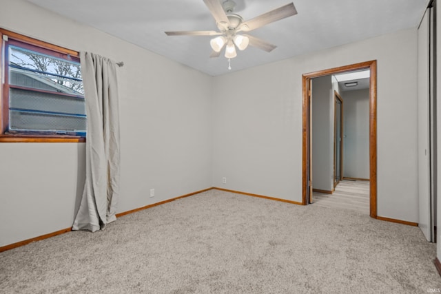 spare room with light colored carpet and ceiling fan