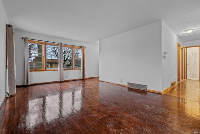 spare room with wood-type flooring