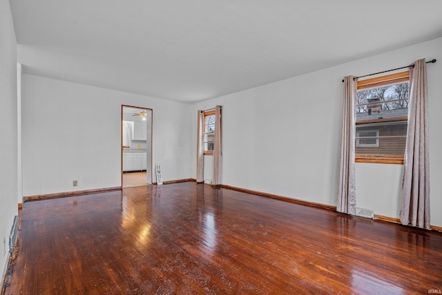 spare room with hardwood / wood-style flooring and ceiling fan