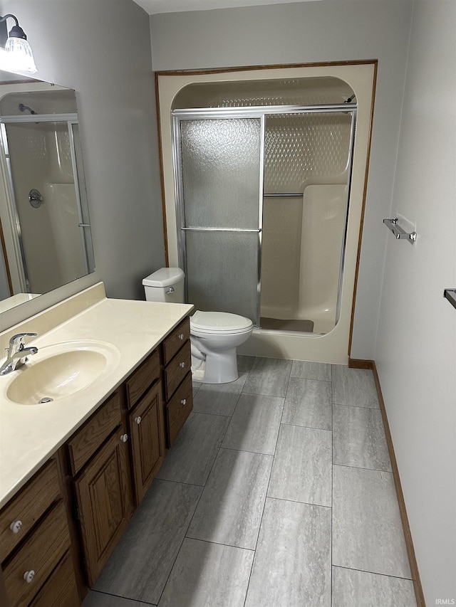 bathroom with vanity, toilet, and walk in shower