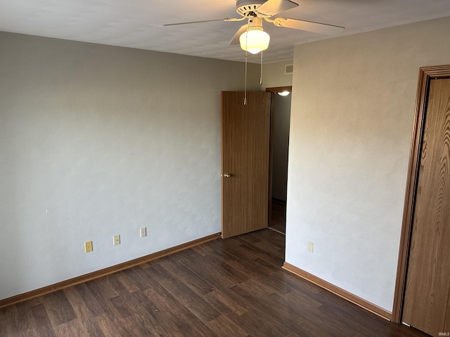 spare room with ceiling fan and dark wood-type flooring