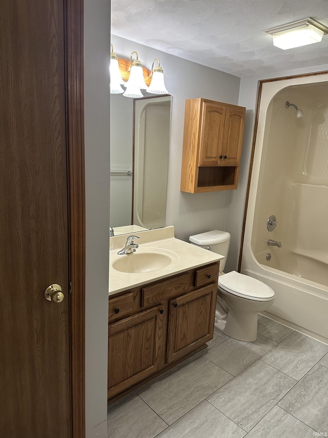 full bathroom with tile patterned floors, vanity, a textured ceiling, bathing tub / shower combination, and toilet