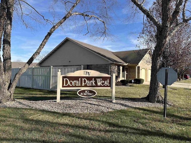 community / neighborhood sign featuring a lawn