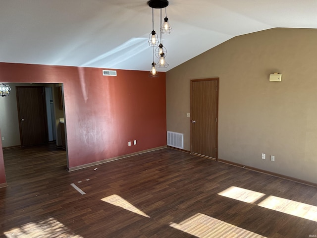 unfurnished room featuring lofted ceiling and dark wood-type flooring