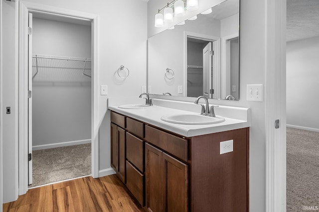 bathroom featuring hardwood / wood-style floors, vanity, and a textured ceiling