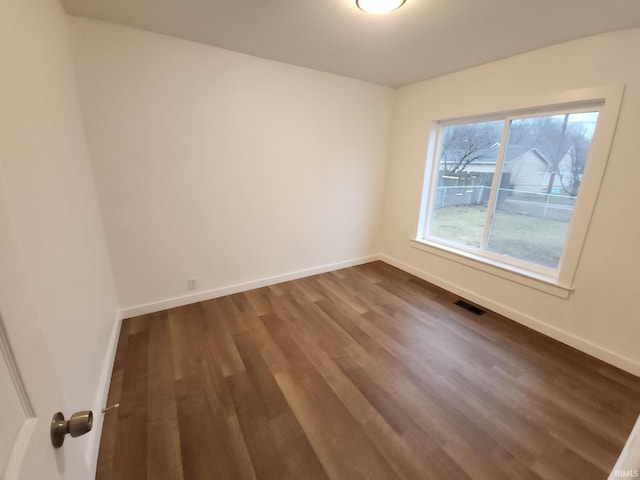 empty room with hardwood / wood-style flooring