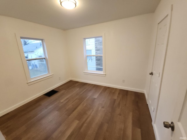 unfurnished bedroom with dark hardwood / wood-style flooring