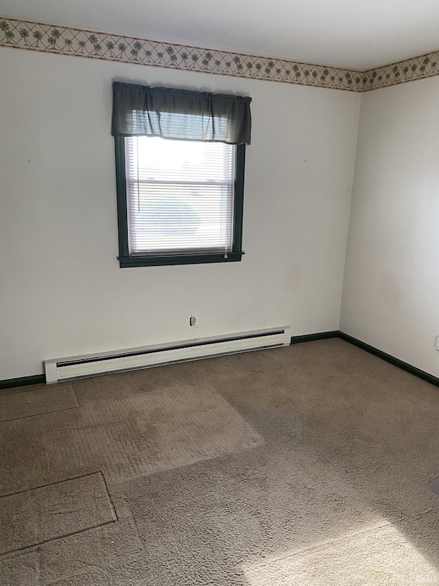 carpeted empty room featuring a baseboard radiator