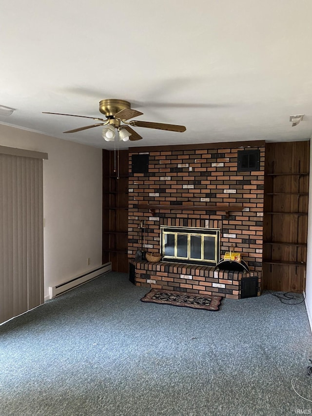 unfurnished living room featuring baseboard heating, wooden walls, ceiling fan, a fireplace, and carpet floors