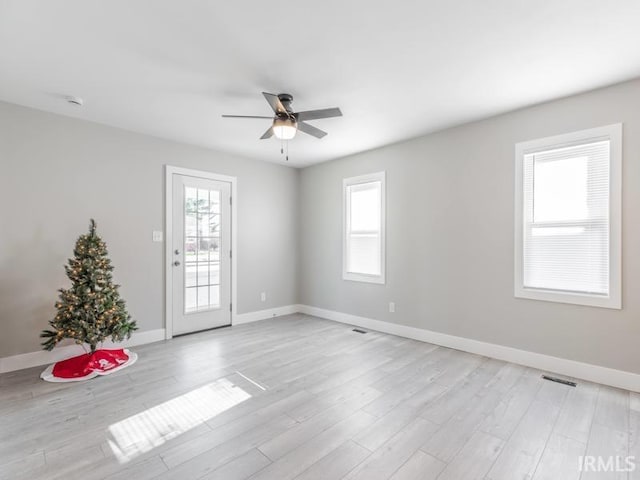 unfurnished room with light hardwood / wood-style flooring and ceiling fan