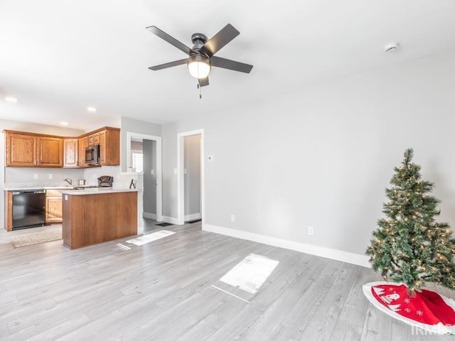 kitchen with kitchen peninsula, black dishwasher, light hardwood / wood-style flooring, and ceiling fan