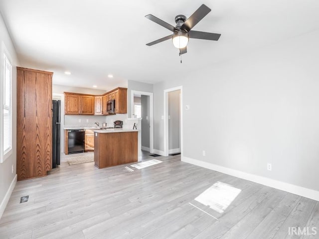 kitchen with black dishwasher, light hardwood / wood-style flooring, and ceiling fan