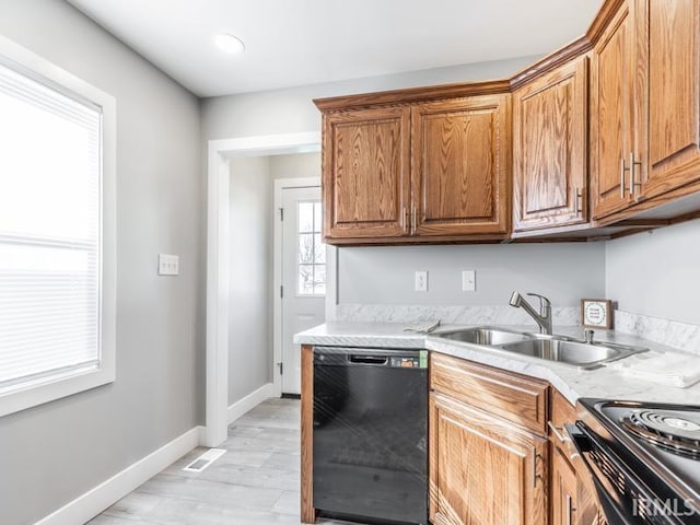 kitchen featuring light wood-type flooring, sink, and black appliances