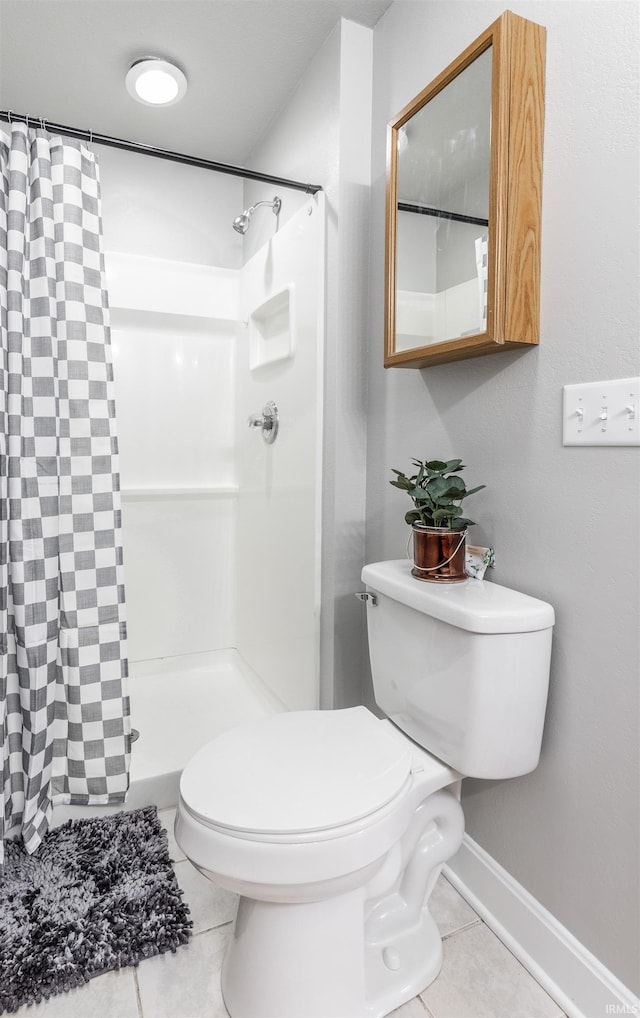 bathroom with toilet, a shower with curtain, and tile patterned floors