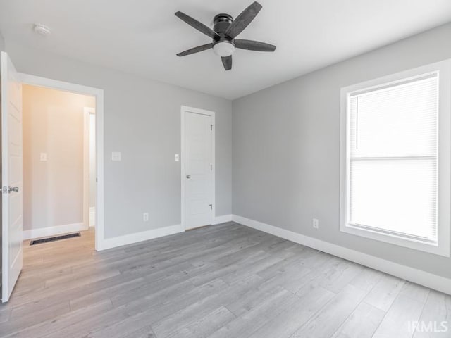 spare room featuring light wood-type flooring and ceiling fan