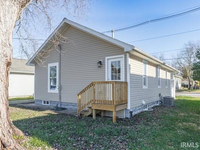 view of side of home with a yard and cooling unit