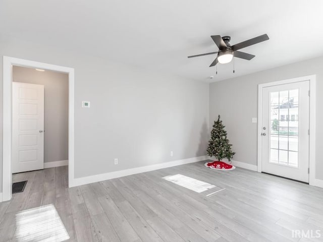 unfurnished room with light wood-type flooring and ceiling fan