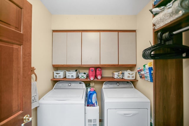 laundry area with cabinets and separate washer and dryer