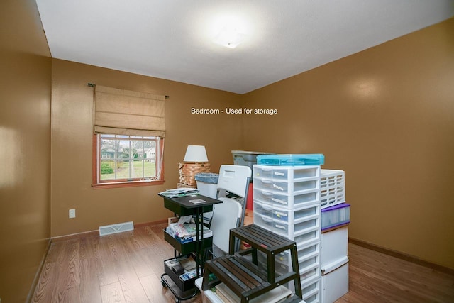 home office with wood-type flooring