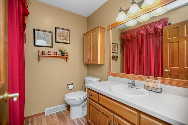 bathroom featuring hardwood / wood-style floors, vanity, and toilet