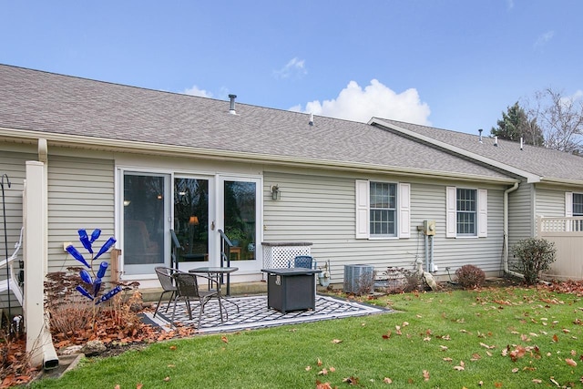 back of house featuring a lawn, central AC, and a patio