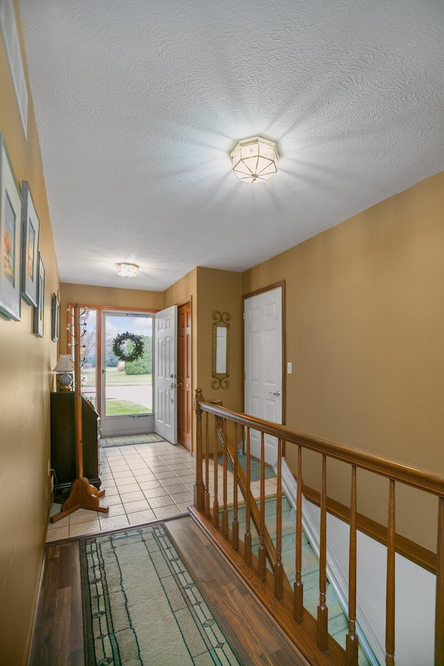 interior space featuring a textured ceiling and light hardwood / wood-style flooring