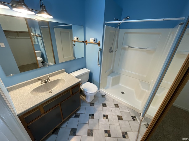 bathroom with vanity, toilet, and walk in shower