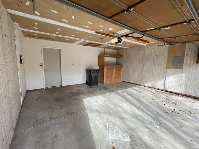 garage with electric panel and a garage door opener