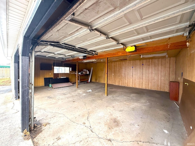 garage featuring wooden walls and a garage door opener