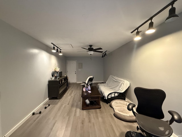 home theater featuring ceiling fan and light hardwood / wood-style flooring