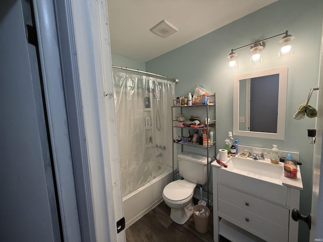 full bathroom with hardwood / wood-style floors, vanity, toilet, and shower / bath combo