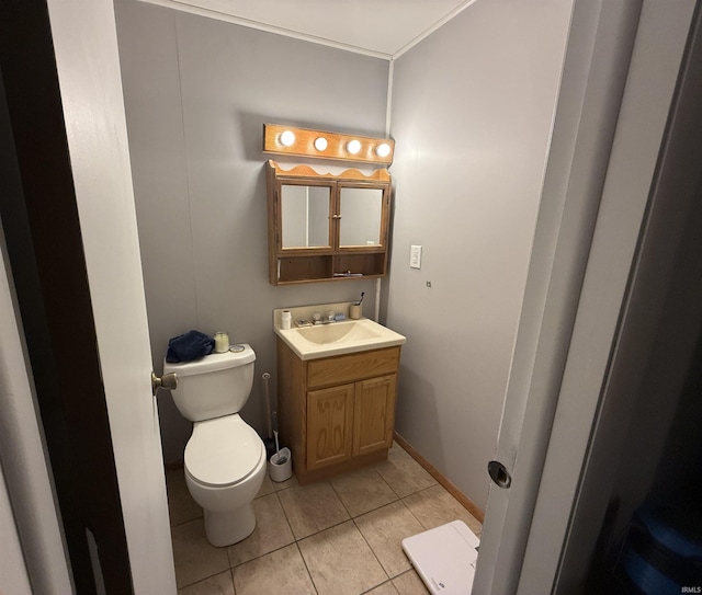 bathroom featuring tile patterned floors, vanity, and toilet