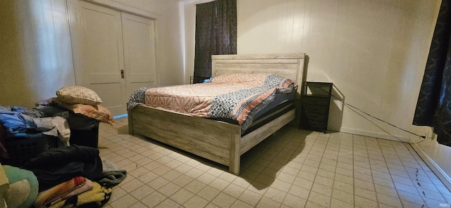 bedroom with light tile patterned floors and a closet