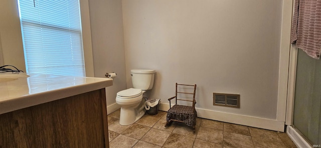 bathroom featuring vanity, toilet, and walk in shower