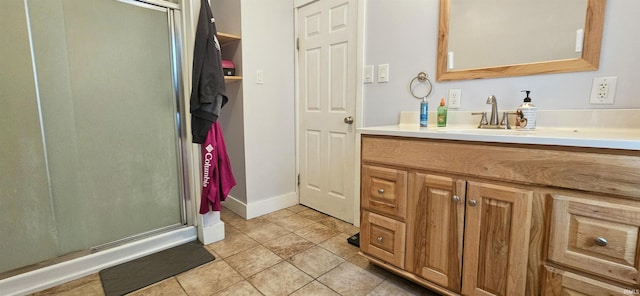 bathroom featuring tile patterned flooring, vanity, and a shower with shower door