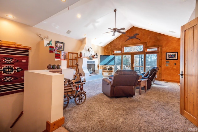 living room featuring ceiling fan, carpet floors, and lofted ceiling