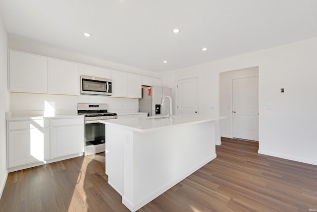 4528 Timber Creek Pkwy, New Haven, IN 46774 - kitchen featuring dark wood-type flooring, a center island with sink, sink, appliances with stainless steel finishes, and white cabinetry