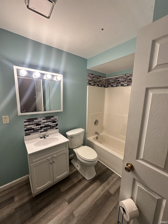 full bathroom with vanity, hardwood / wood-style floors, shower / bathing tub combination, and toilet