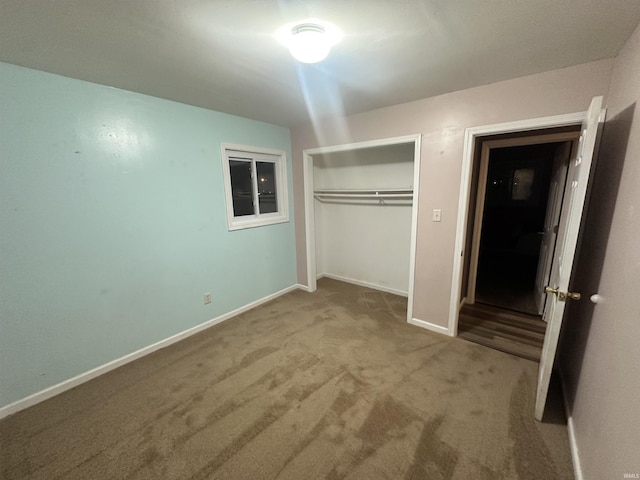 unfurnished bedroom with a closet and light colored carpet